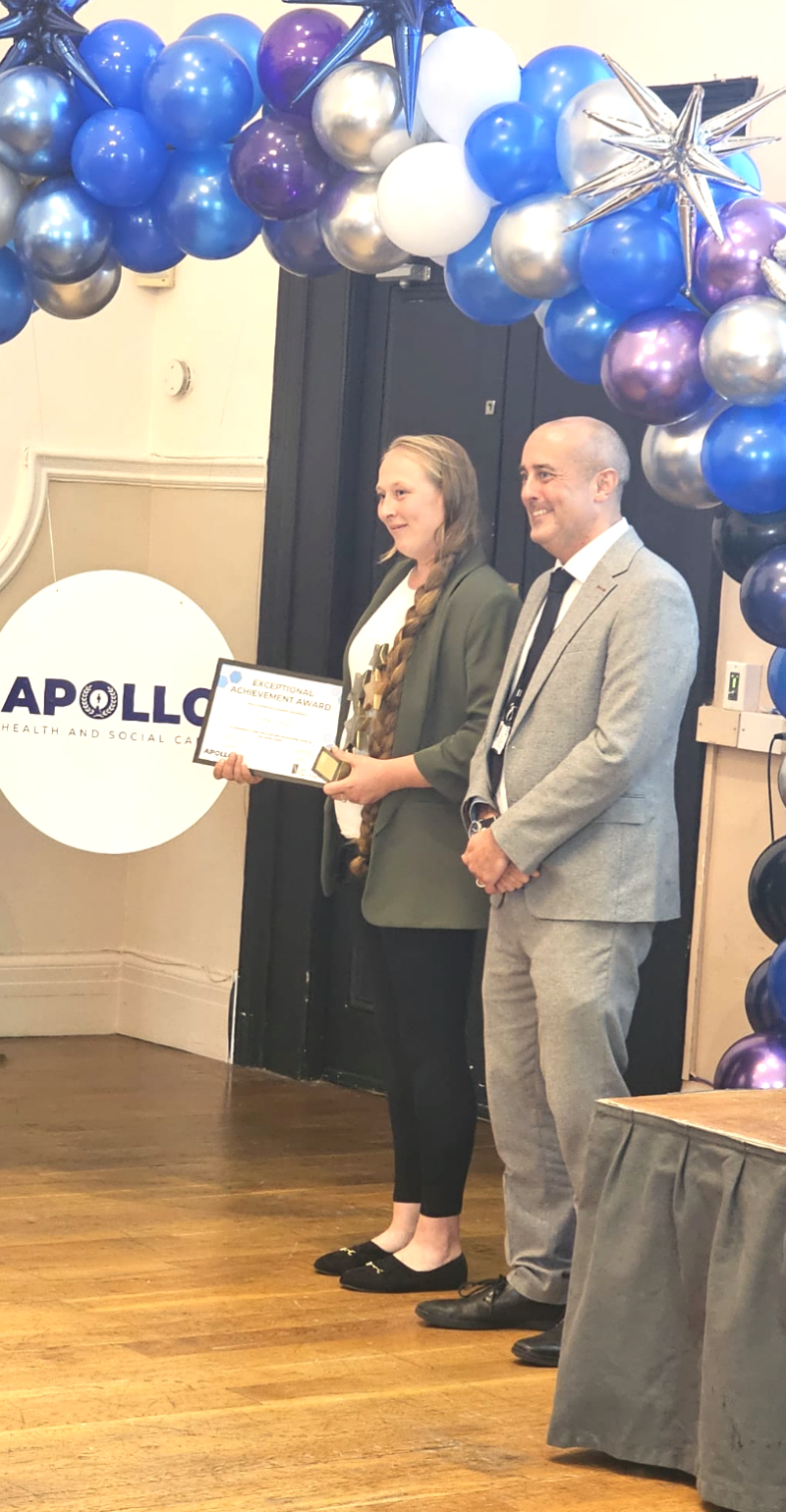 Two people standing at an award ceremony