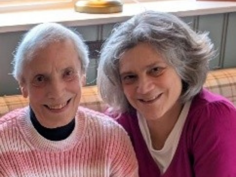 Two women sitting together and smiling
