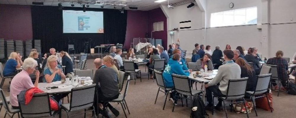 Groups of people sitting at event tables